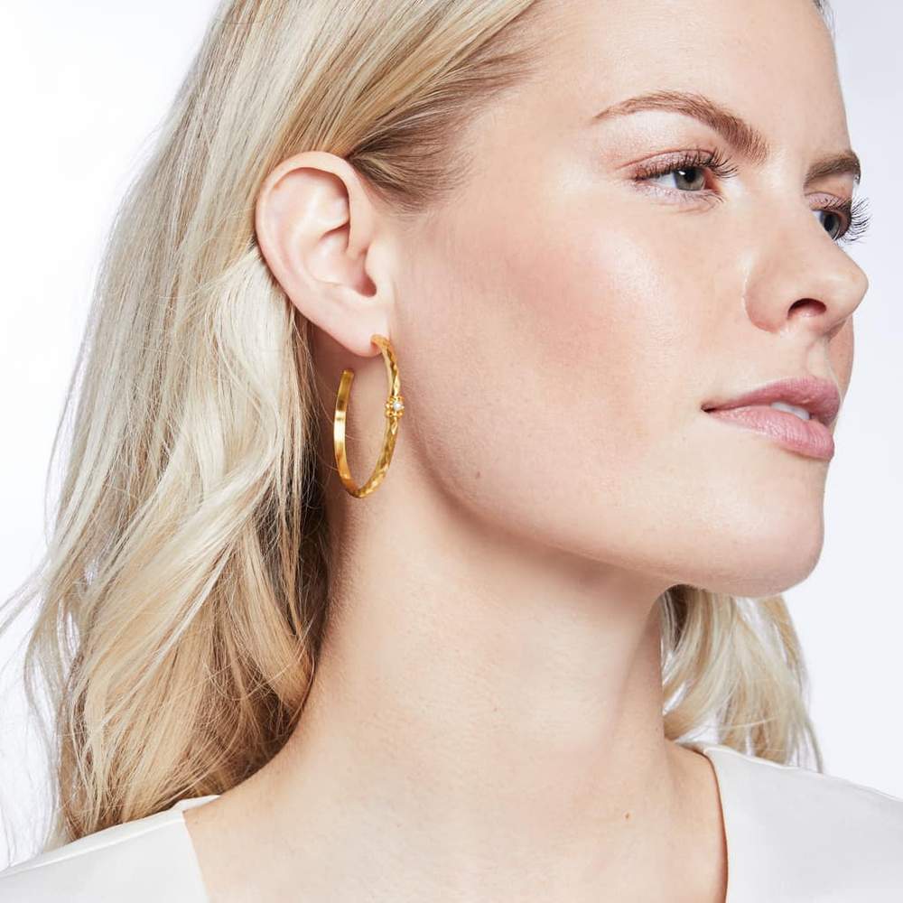 These Savannah 24k gold plate hoop earrings are a classic staple for your jewelry box. Featuring a hammered hoop with a freshwater pearl station right in the front. Savanah Hoop