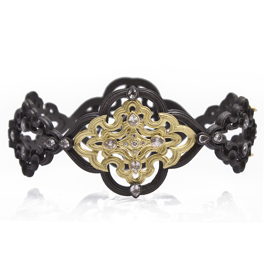 This gorgeous Armenta statement bracelet is handmade in TX using blackened sterling silver with a yellow gold. Displaying white sapphires and white diamonds, this huggie bracelet is perfect to pair with anything from the Old World Collection. Large Open Scroll Bracelet
