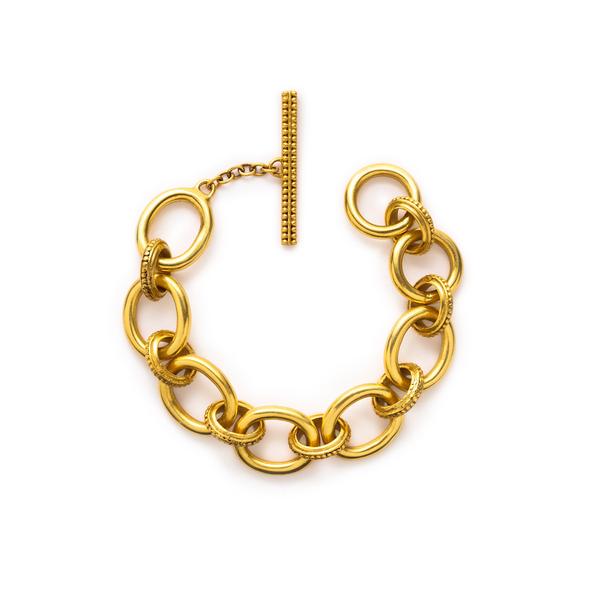 24K gold plated links alternate intricate droplets and matte gold óîculminating in a striking beaded toggle. Shop this bold bracelet: Siena Link Bracelet