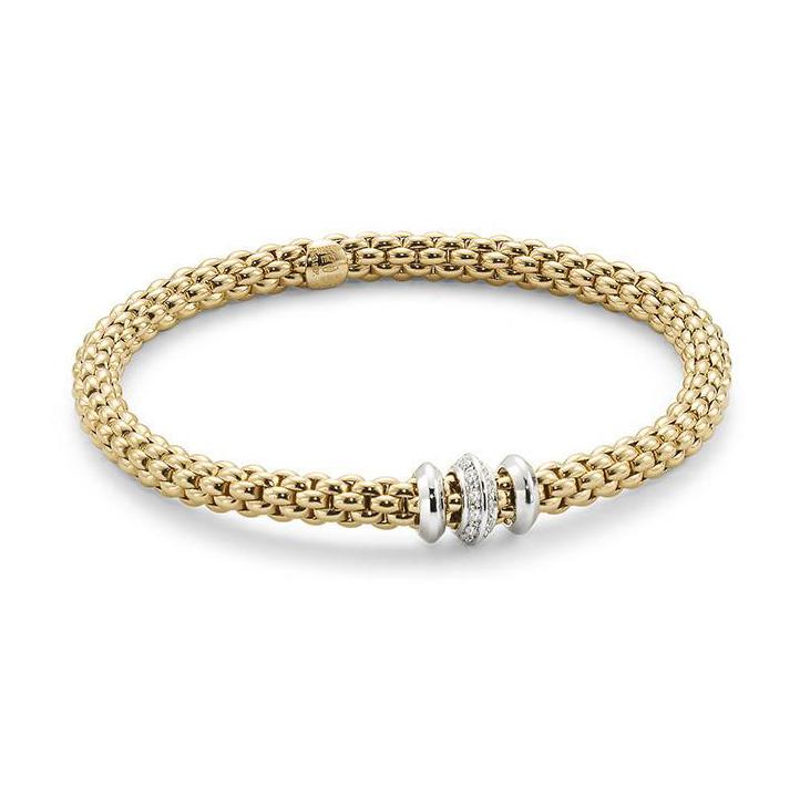 The Solo collection brings a new contemporary slant to Unica, the brand’s best-selling range in the Nineties. The bracelet’s gold mesh is now flexible, the proportions are slightly smaller than the thicker chains in vogue at the time, and there are numerous new versions with gold loops, pearls and diamonds in different carats. The matching set also includes chokers, chain and tassel necklaces, earrings and rings.
The effortless simplicity of every Fope Bracelet ensures that you don't have to sacrifice your comfort for fashion. Classic yet fashion forward, this is most certainly not your grandmothers jewelry, each piece of FOPE gives an aura of inteligence and sohistication to those who wear it.
Each bracelet has over 100 tiny 18k gold coils set into the interior of the link that allows the bracelet to expand and contract, rolling perfectly onto your wrist with ease. Handcrafted Entirely in Italy from 18k Gold and Diamonds, This Solo Flex'It Bracelet in size Medium features three rondels, two white gold rondels that flank one diamond encrusted rondel that sports two rows, 0.17cts, of VS F/G Diamonds.
FOPE Flex'It Bracelets are made in Five Sizes - Extra Small(15cm.), Small(16cm.), Medium(17cm), Large(18cm), and Extra Large(19cm). Standard size is considered Size Medium and fits most people. There are price differences between each size so please reach out to us for pricing information.
Size/Color Avaliable for Immediate Shippment is Size Medium in Yellow Gold with White Gold and Diamonds Rondel. All other sizes/colors will be ordered with a 4-6week lead time.
Solo FLEX'IT Bracelet - 653 BBRM