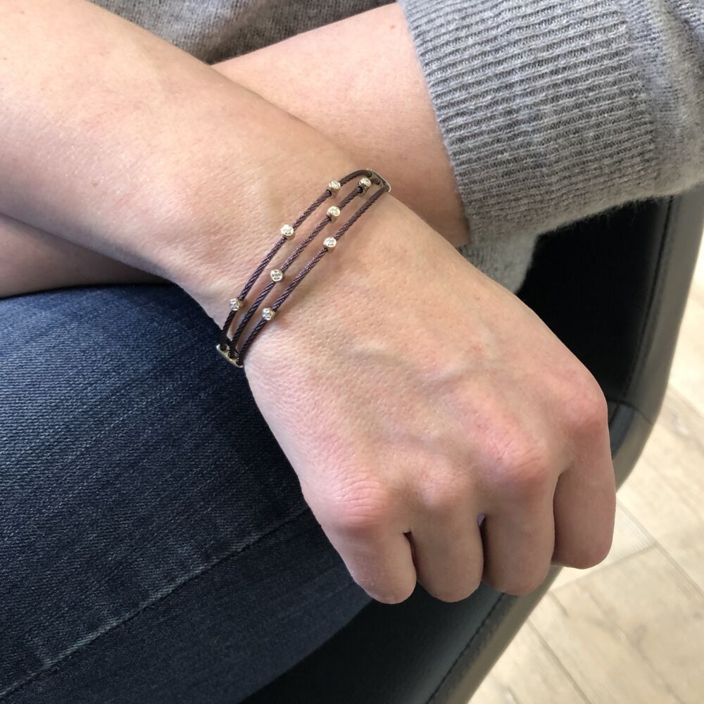 This beautiful burgundy lightweight, heat treated steel cable bracelet features scattered stations of 18k yellow gold with set diamonds. With a total diamond weight of .11 CT. Burgundy Small Constellation Bracelet