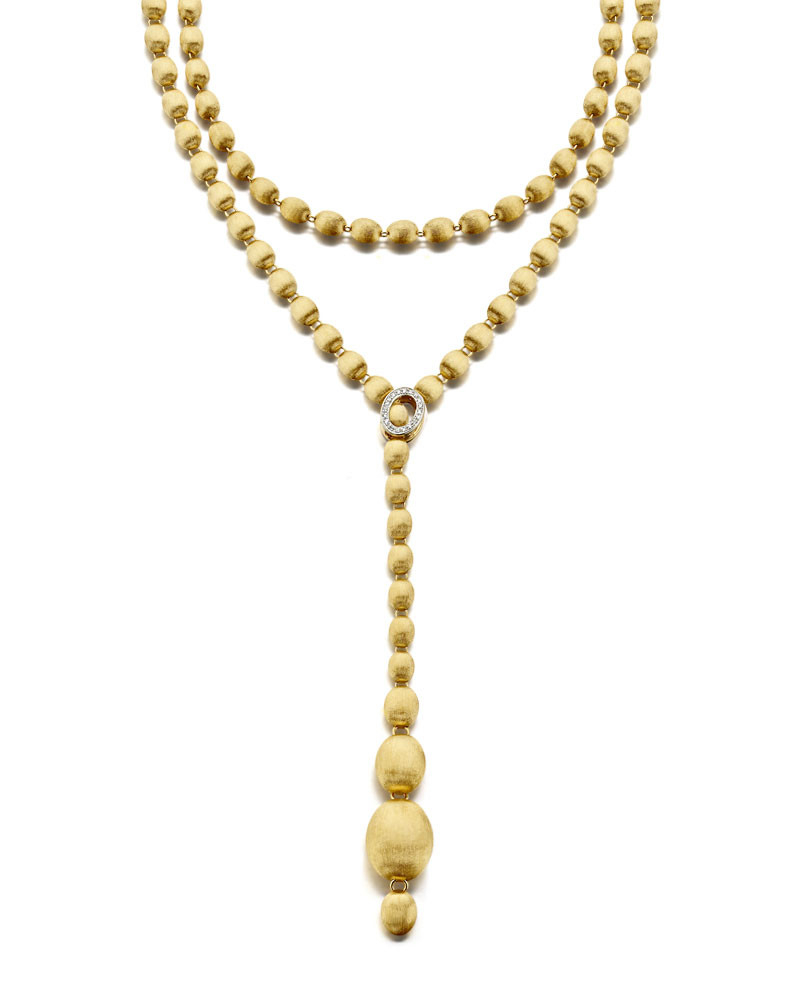 This Ivy necklace in 18kt yellow gold and diamonds is made from elegant gold pearls, hand-engraved one by one with the very ancient burin technique and surprisingly light. Versatile in style, wear as a long chain or Lariat, double or triple the strands around your neck or down your back. It's easily the sexiest most versatile necklace you can own. Ivy Necklace