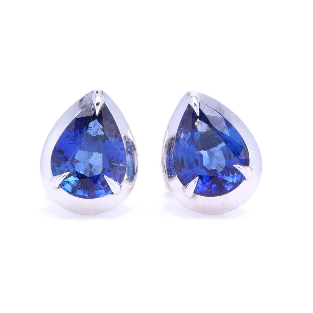 These are an elegant pair of pear shaped blue sapphires studs bezel set in 18 white gold. Celebrate a September birthday or just the love of blue. These are stylish and classic yet substantial with 1.9 carats of weight. Pear Shaped Blue Sapphire Bezel Set Studs in 18k White gold