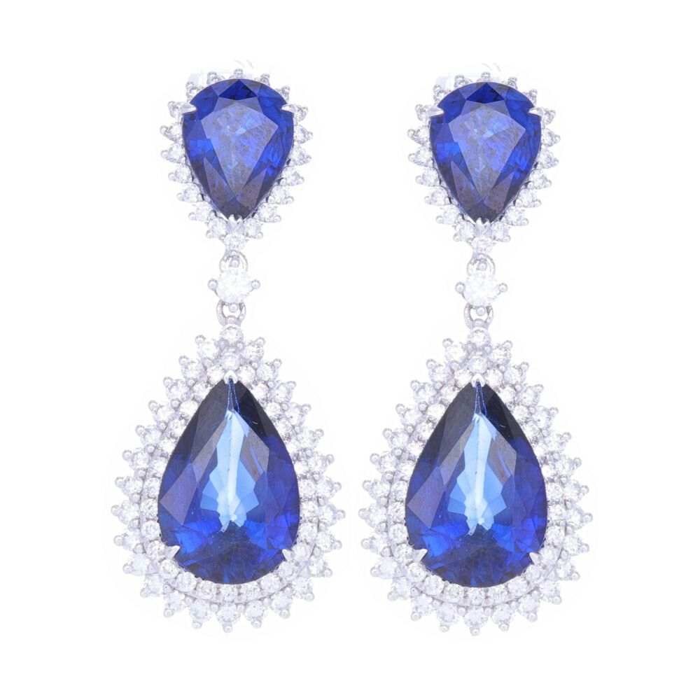 These 14k white gold diamond and diffused blue sapphire earrings are sure to be a show stopper. With 2.5 carats of round diamonds and 20 carats of blue sapphires, these elegant and sexy dangle earrings are perfect for a night out on the town. 14k White Gold Round Diamond and Diffused Sapphire Earrings