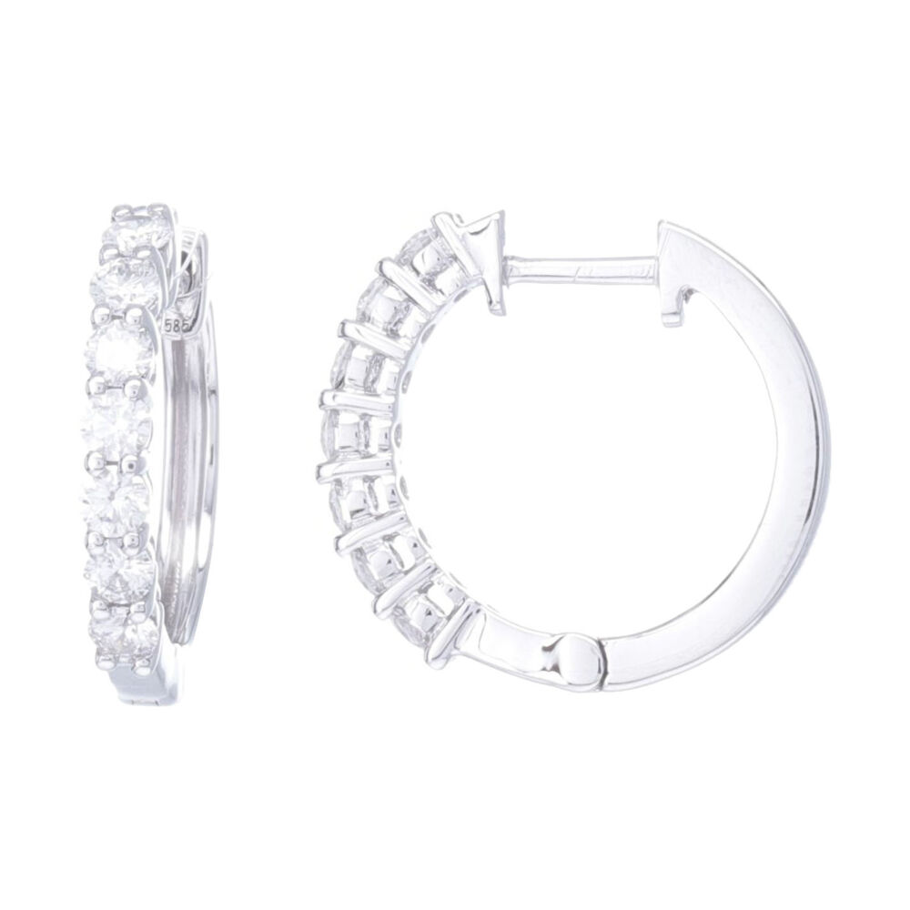 Fun, sparkly, every day hoop earrings. .57 carats of prong set brilliant cut white diamonds are set in 14k white gold. Just enough sparkle to catch the eye yet understated enough to make you'r every day earring. Easily wear charms on these or wear by themselves. Prong Set Brilliant Cut Diamond Huggie Hoop Earrings