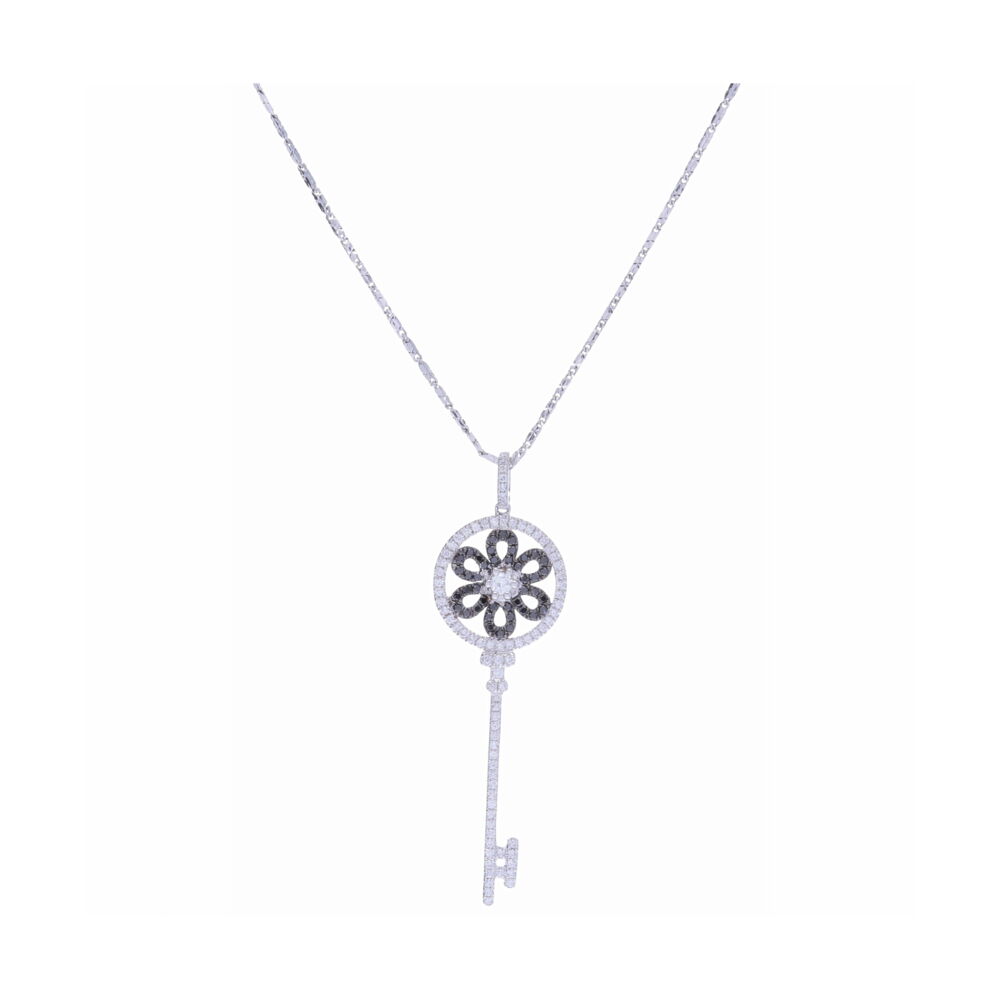 This 14k white gold black and white diamond key necklace has a total of .65 carats of round diamonds. This versatile necklace can be worn alone as a statement piece or layered with other necklaces. This elegant and timeless necklace is key piece to have in your jewelry collection. 14K White Gold Black and White Diamond Key Necklace