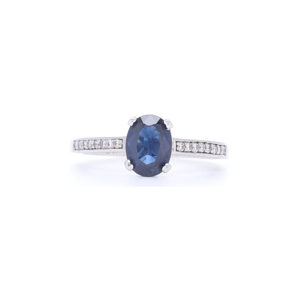 This classic oval shaped sapphire ring has pave diamonds down the shank. The 1.23 carat Oval is set into 14k white gold with .33 carats of diamonds down the sides. Stunning Blue Oval Shaped Sapphire Ring with Diamonds 1/2 down the Shank