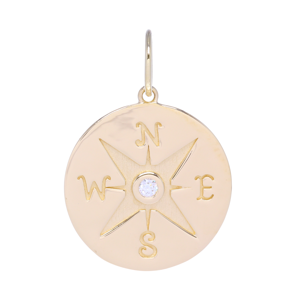 This Large 14k gold pave diamond compass medallion charm is perfect for being a base charm in layering or being on it's own. It contains 4 g of 14k gold and .05 carats of diamonds. This charm can fit on a chain up to 8mm in gauge but is often worn with one of the open-able ring chains. The compass means many things but to most it symbolizes the ability to point you in the right direction.
Gold Compass Medallion Pendant with Diamonds