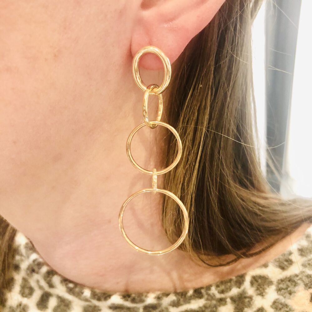 These 14k gold and diamond 5 hoop earrings are bound to turn heads. One of the five hoops contains .12 carats of pave set diamonds, making these earrings sexy, sleek and perfect for a night out on the town. 14k All Gold 5 Ring Diamond Earrings