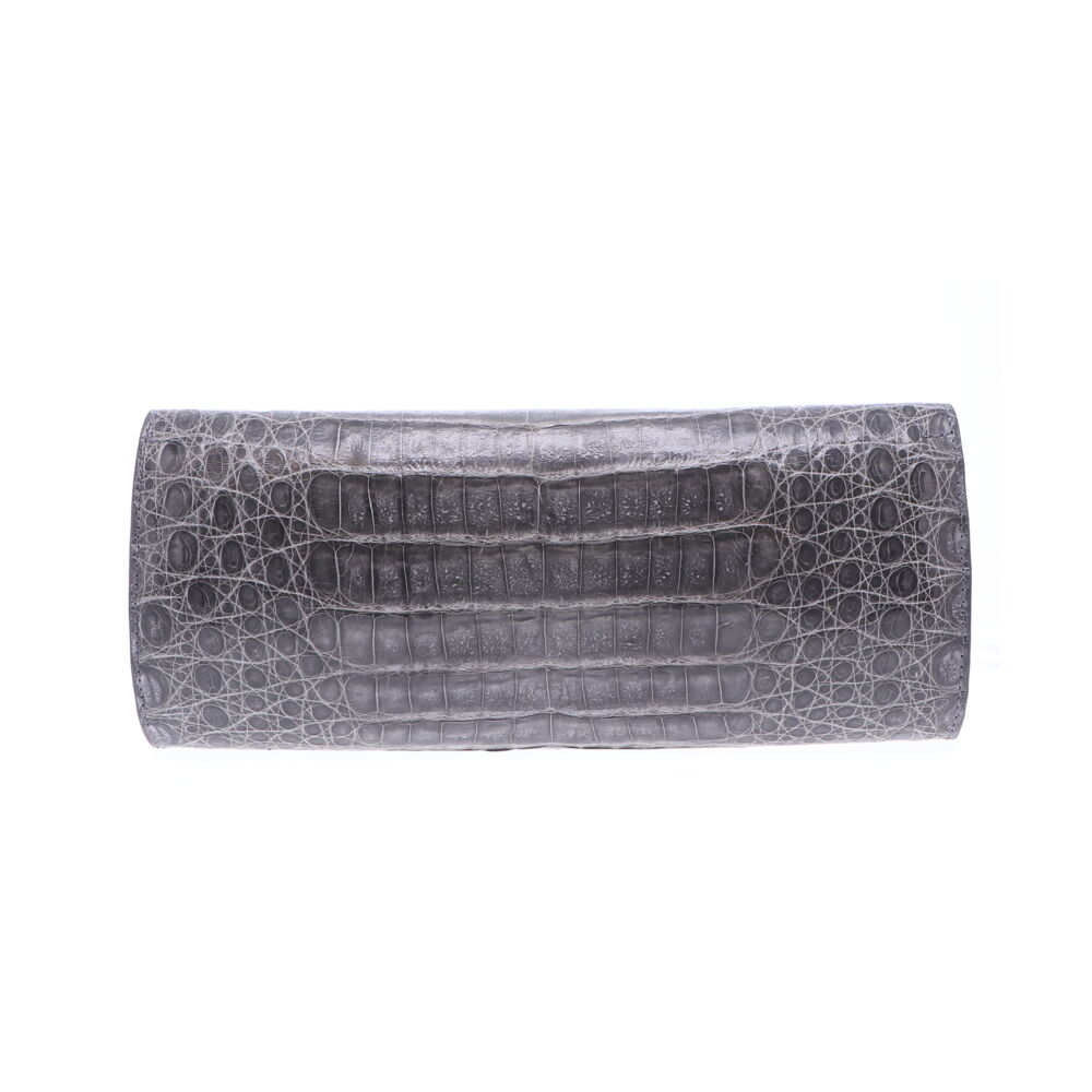 LaNae’s Day Clutch is made from genuine Caiman Crocodile skin. Proudly handcrafted in the USA by 3rd generation artisans, all edges are hand painted, interior is garment suede and is detailed with Italian palladium hardware. Each luxury bag is one of a kind and especially made for you to stand out against the crowd! Contact the store for additonal photos. Grey Cayman Crocodile Day Clutch