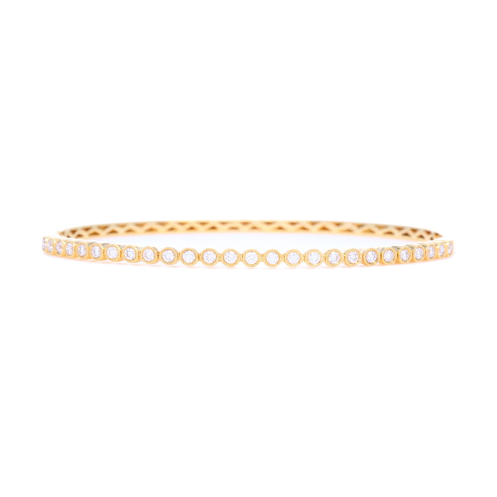 This 18k yellow gold bezel set diamond bangle is fits up to a 6.5 inch wrist and is the perfect addition to your jewelry collection. This bangle is perfect for stacking alongside other bracelets but is versatile enough to be worn alone as well. Whether you wear this bangle out on the town or day-to-day, its beauty is bound to turn heads. 18k Yellow Gold Diamond Bezel Set Bangle