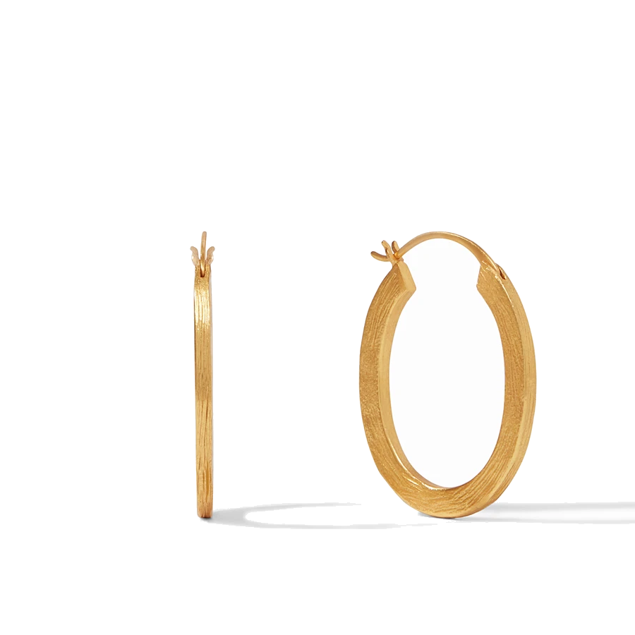 Golden oval hoops with a textured finish inspired by the bark of an Aspen tree.
Model is wearing size Large. Aspen Hoop Gold