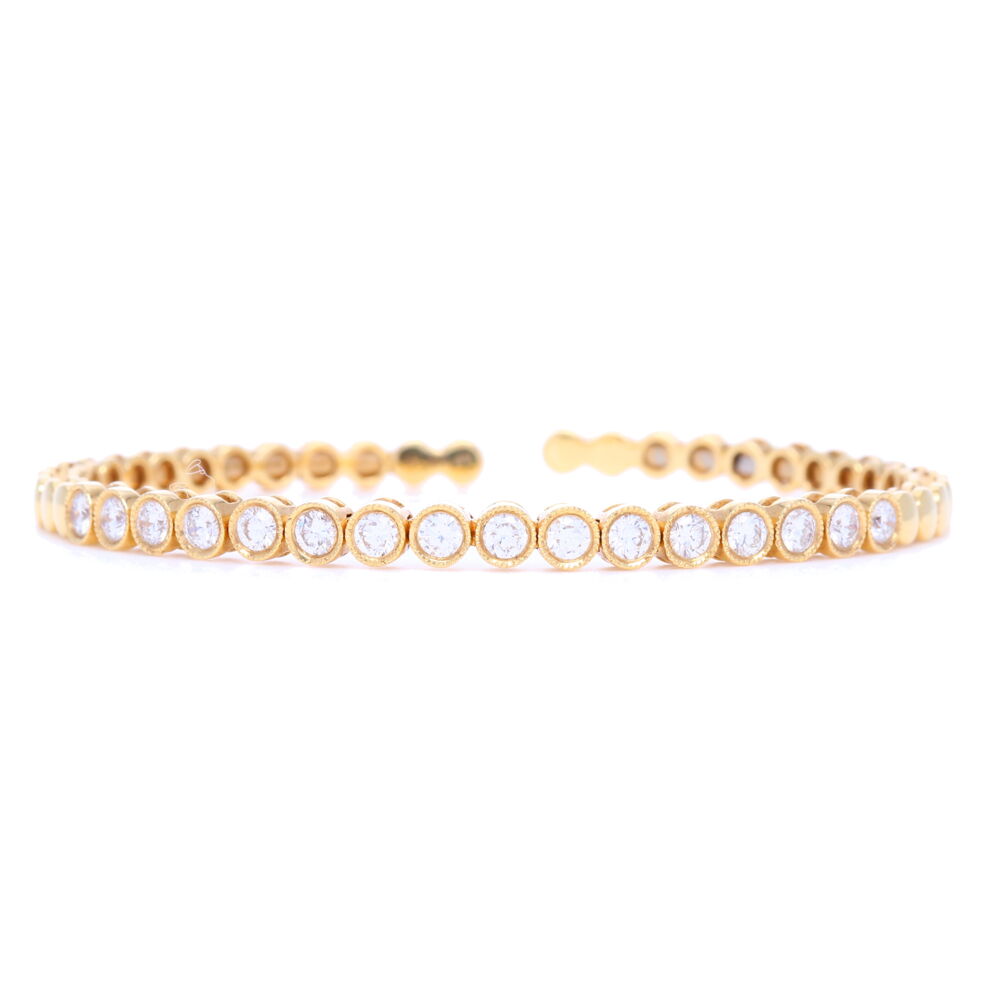 This 18k yellow gold classic bezel set diamond cuff bracelet is a staple piece to any jewelry lovers collection. With 2.5 carats of diamonds, this cuff is stackable, flexible and bendable, making it the perfect versatile bracelet. 18k Classic Bezel Set Diamond Flexible Bracelet