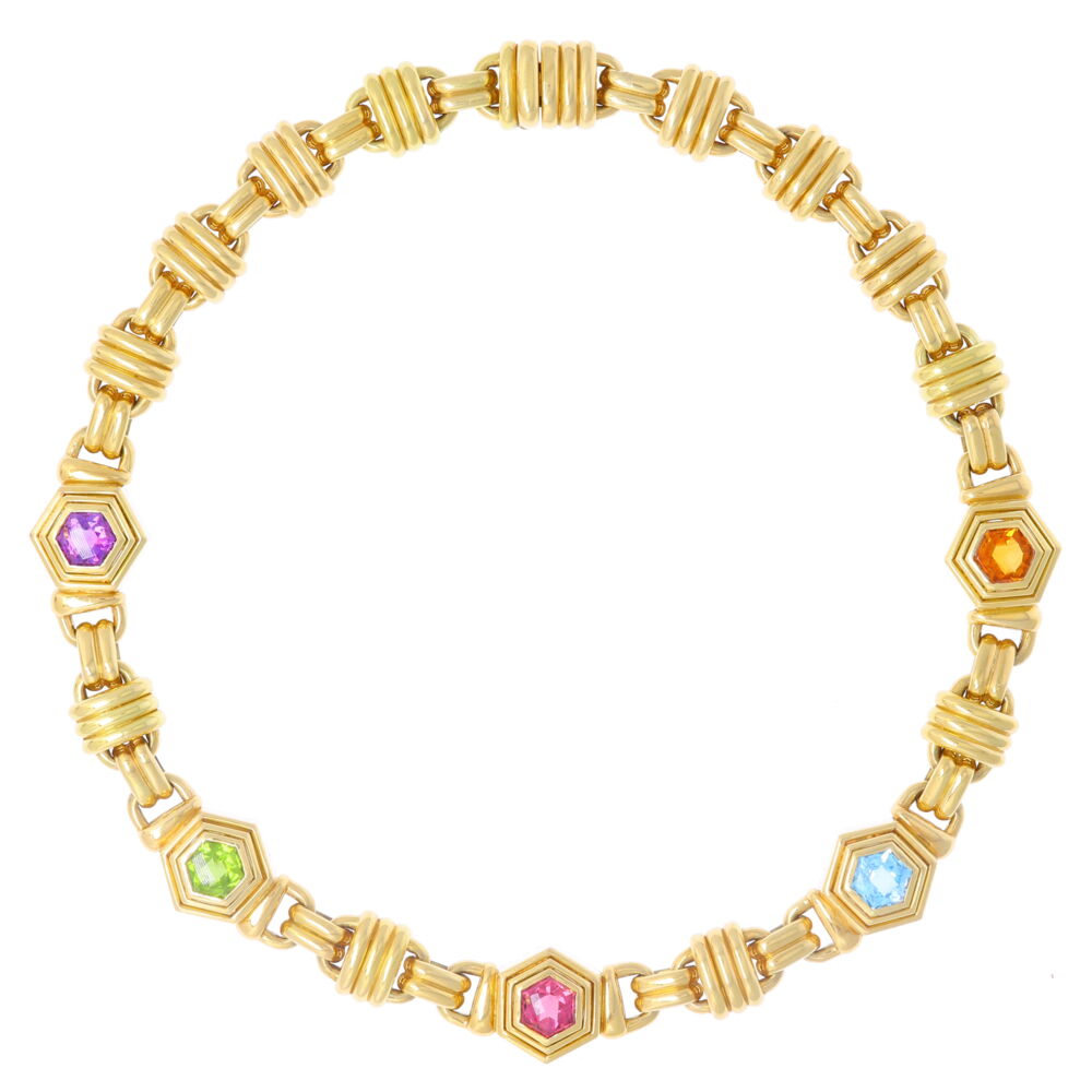This stunning link collar necklace features five colored stones including Citrine, Peridot, Pink Tourmaline, Blue Topaz, and Amethyst. This vintage one of a kind collar necklace features five colored stones: Citrine, Peridot, Pink Tourmaline, Blue Topaz and Amethyst. What goes around comes around. Thankfully this gorgeous 80's necklace was saved from the smelter. Truly one of a kind this necklace, and the matching bracelet, can't wait to jump into your jewelry box. Multi Gemstone Collar Necklace