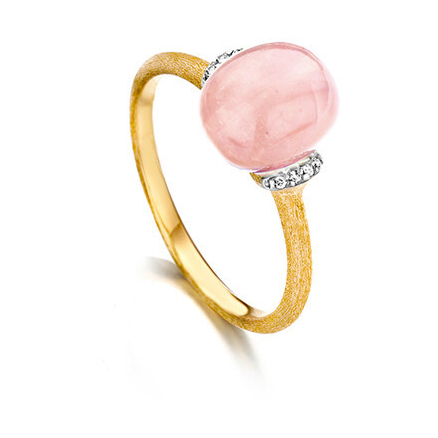 This pretty pink ring is featured in 18k yellow gold, and displays a large 4.75 carat pink chalcedony gemstone with small diamond stations on either side of the gemstone. Dancing Color Pink Chalcedony Ring