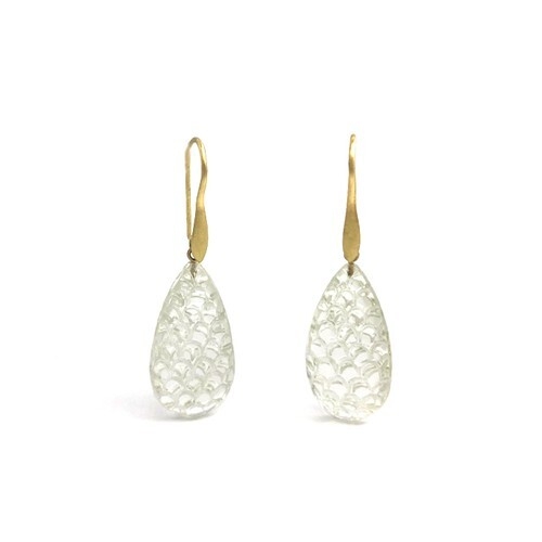 The Carved Rock Crystal Drop Earrings are one-of-a-kind. Rock Crystal is the colorless variety of quartz. These unique briolettes feature a detailed fish-scale pattern that captures light beautifully within the gemstone droplettes. The earrings are made in 18k Yellow Gold with a matte satin finish. One-of-a-kind Now Available at Shop LaNae Carved Rock Crystal Drop Earrings