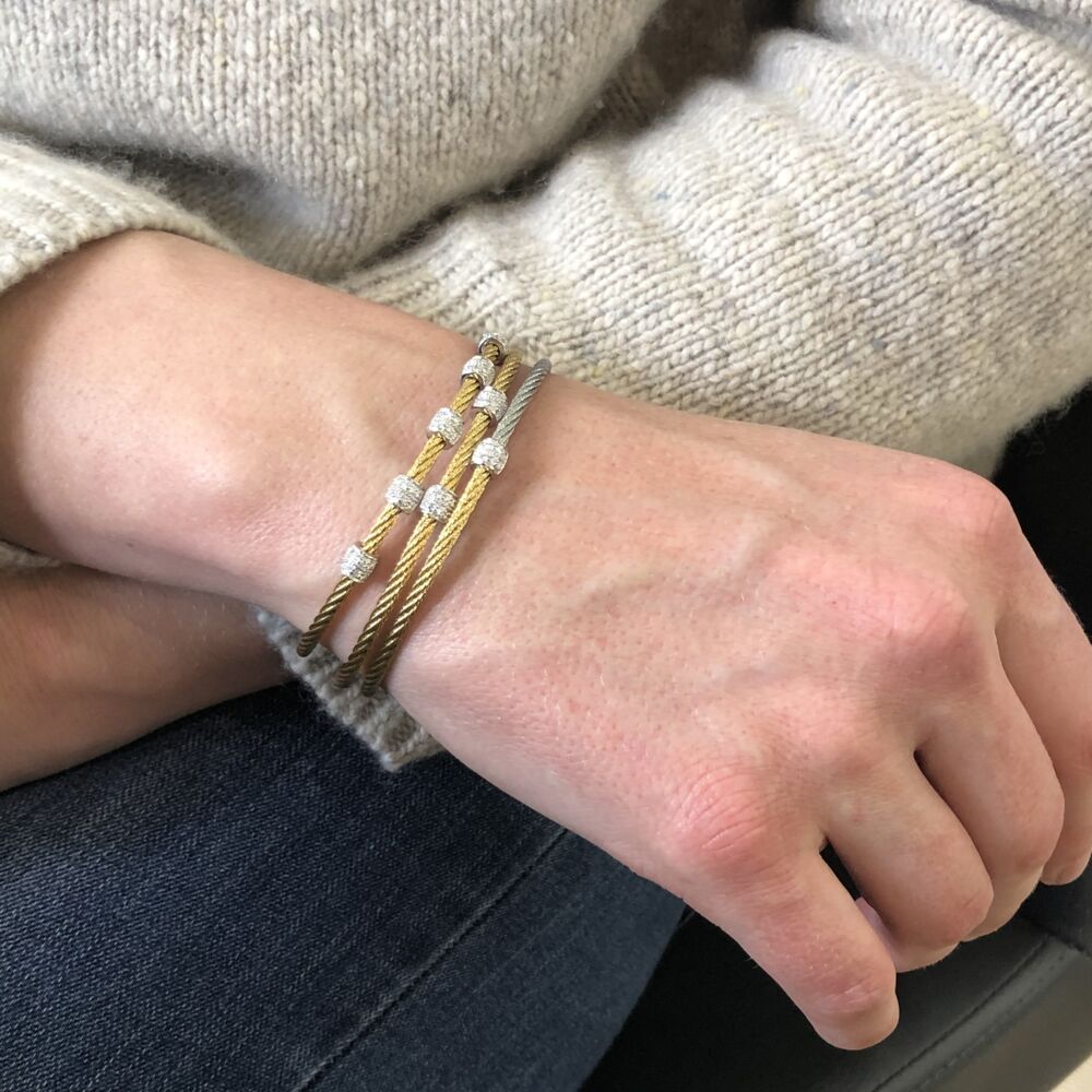 This stunning colorblock bracelet features an 18k white gold barrel station with a total carat weight of .07 carats. This is perfect to layer with others, or wear alone. Color-block Ovaled Station Bangle