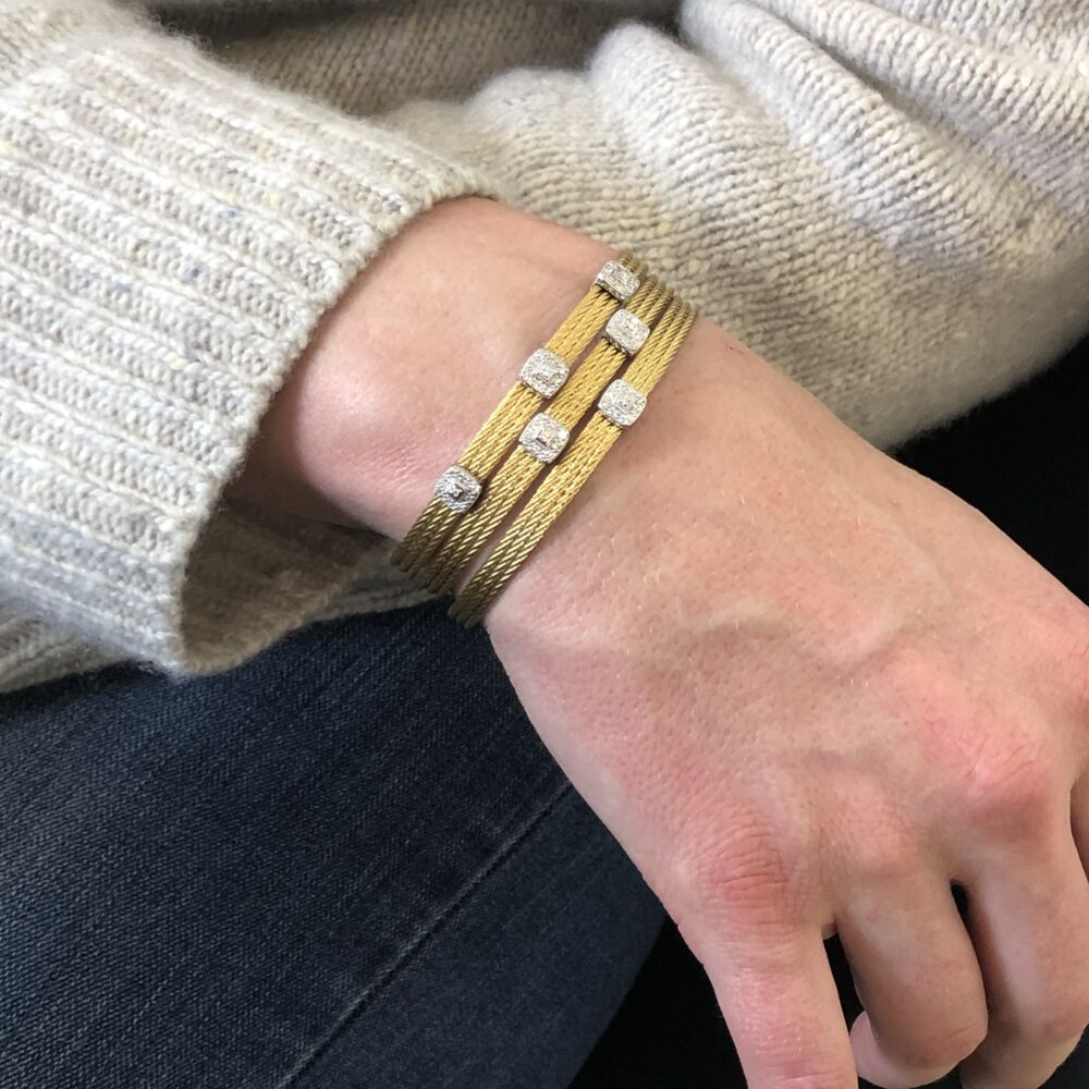This heat treated yellow colored steel cable features two square 18k white gold diamond stations. With a total dimond weight of .09cts, this simply elegant bangle can be worn alone or stacked with others from the Alor collection. Yellow Two Squared Station Bangle
