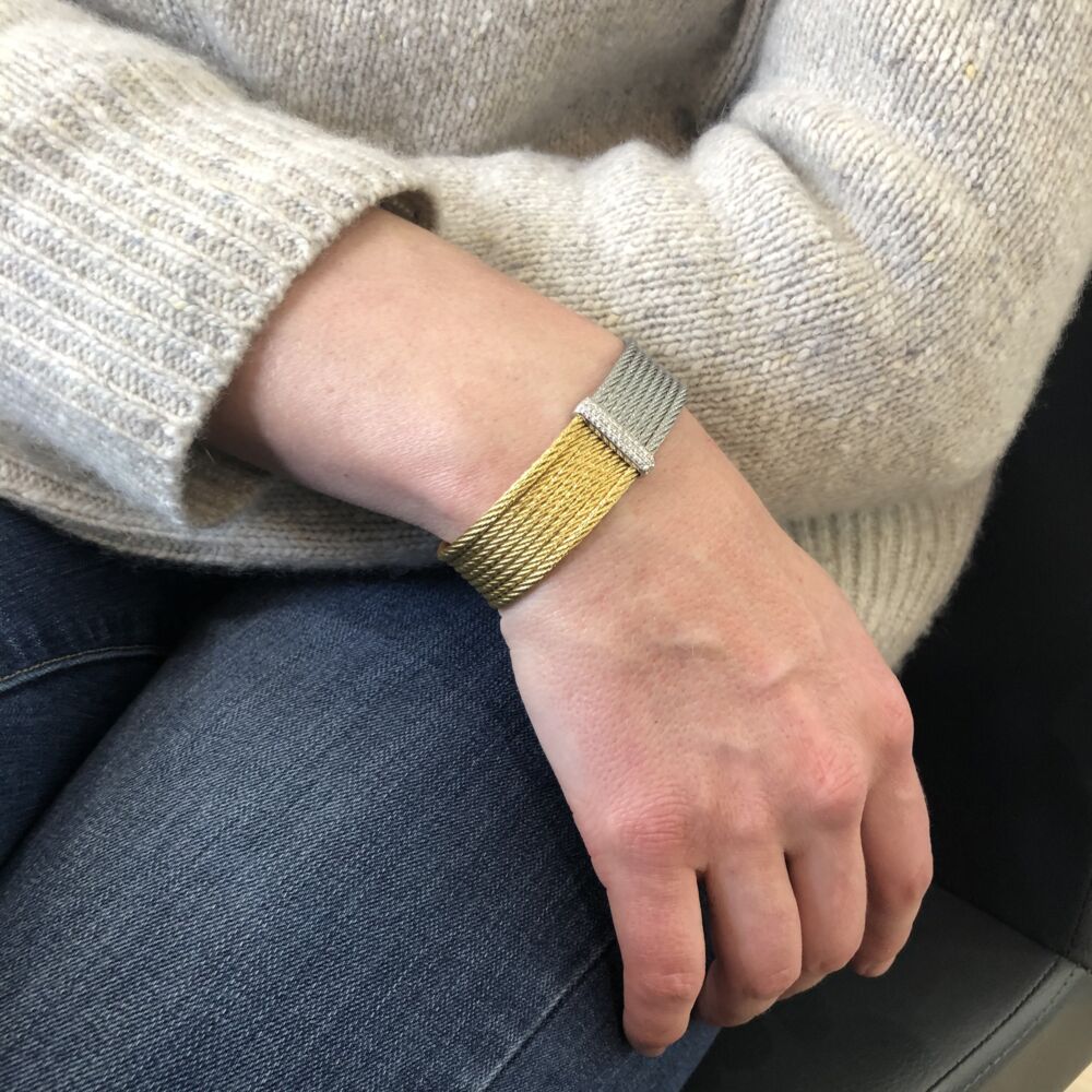 This heat treated yellow colored steel cable cuff features an 18k white gold diamond station with a total carat weight of .34cts. This cuff is perfect to wear alone, or can be stacked with other's from this collection. Classique Two Tone Cuff