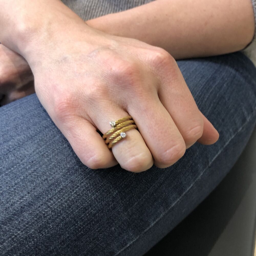 This yellow colored heat treated steel cable features 18k white gold, with a total carat weight of .04 carats. Classique Wrap Ring
