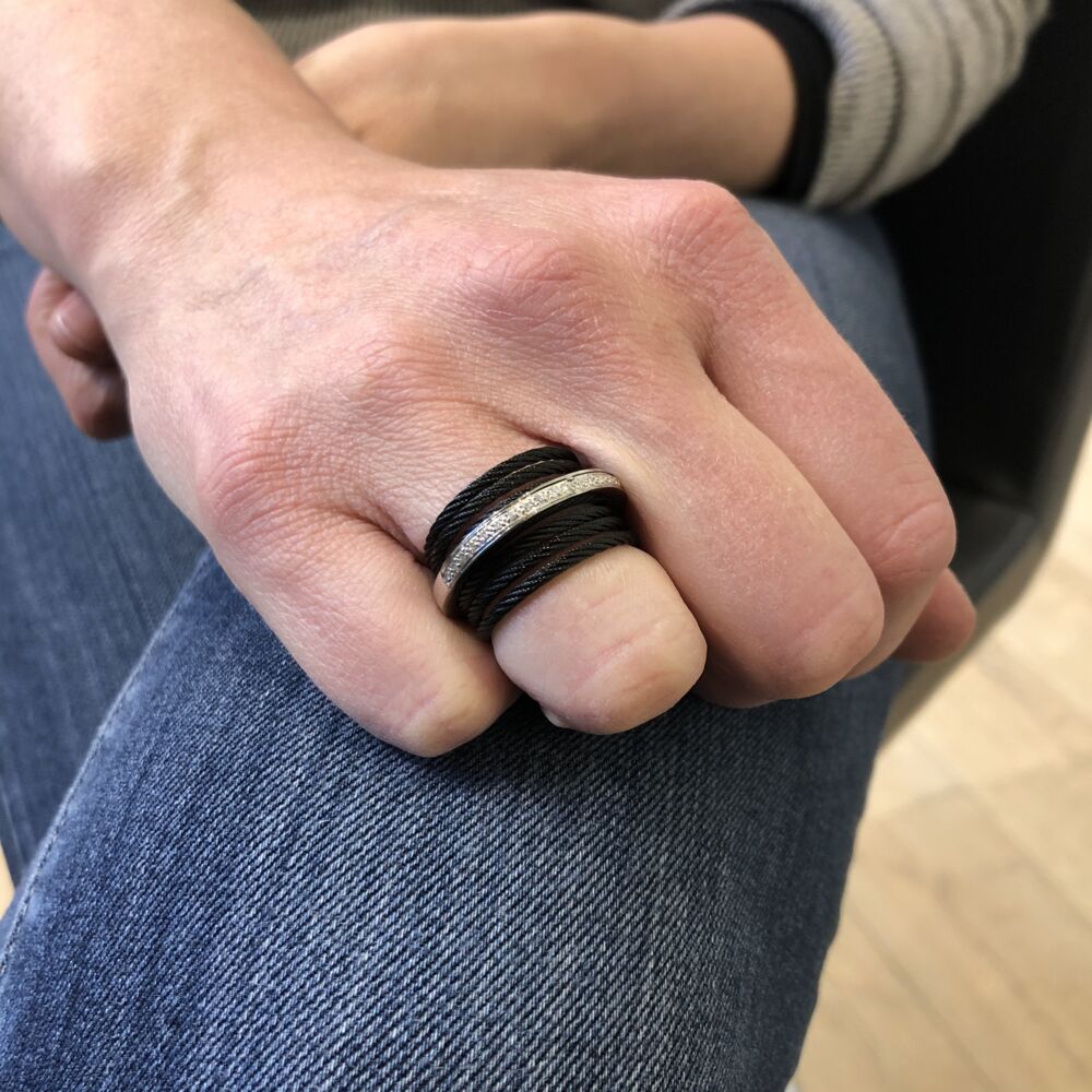 This 6 strand heat treated black cable ring has a middle 18k white gold band displaying a total carat weight of .09cts. This ring is perfect for everyday use, and easily transitions from day to evening wear. Noir Stacked Band Ring