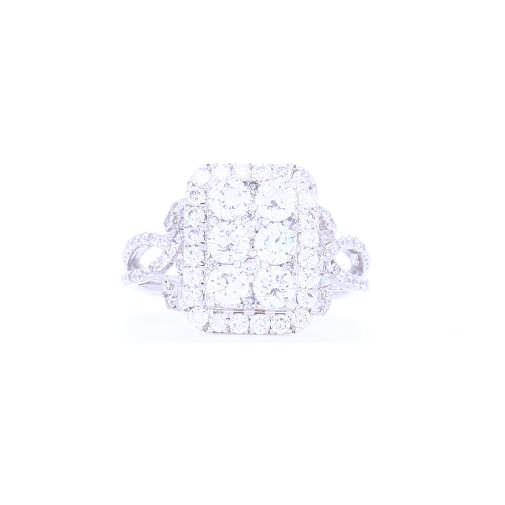 This 18k white gold rectangle shaped cluster ring has 1.81 carats of brilliant cut diamonds set so close together it appears as one large stone. Prong set diamonds down the shank add a beautiful feminine touch to this ring. 18k White Gold Rectangle Shape Cluster Diamond Statement Ring