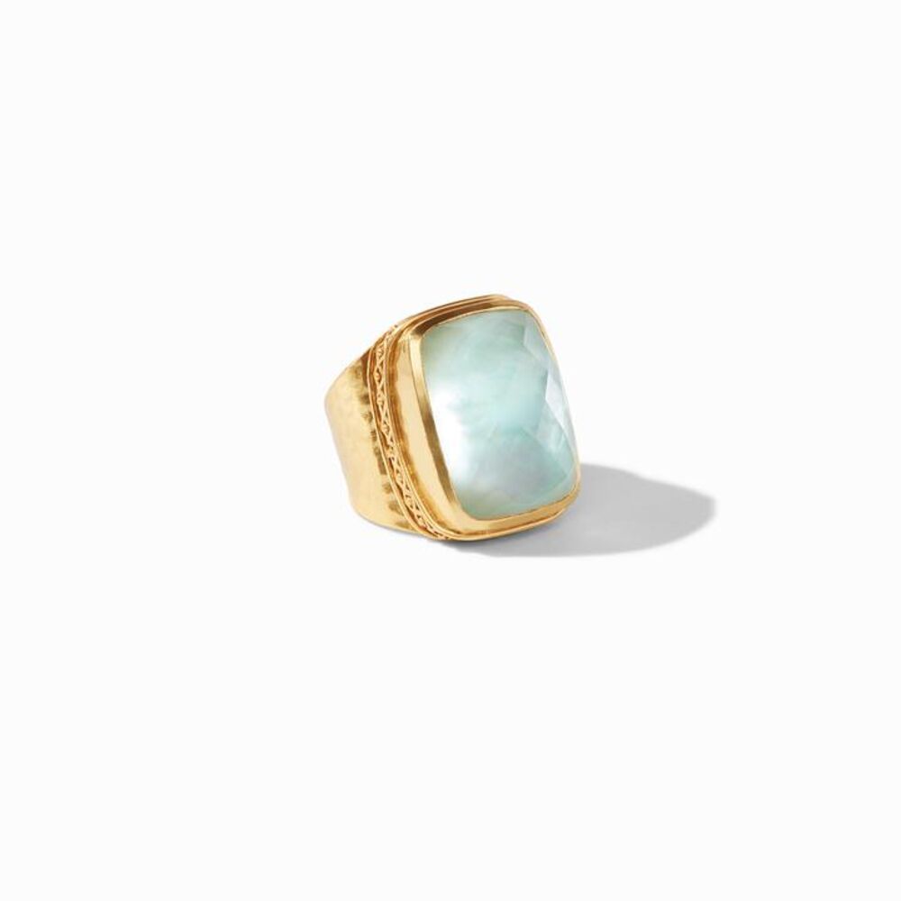 This Catalina Statement Ring features an open band, making this ring perfect for anyone. Displayed in 24k gold plate, with a large center set stone exhibited. Catalina Statement Ring