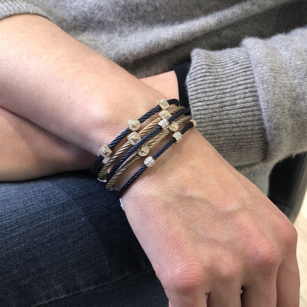 This beautiful blueberry color heat treated cable cable features three squared 18k rose gold stations. The diamond stations carry a total carat weight of .14 carats. This lightweight and durable bracelet would be perfect stacked on top of others, or just worn alone for an elegant simplicity. Blueberry Three Squared Station Bangle