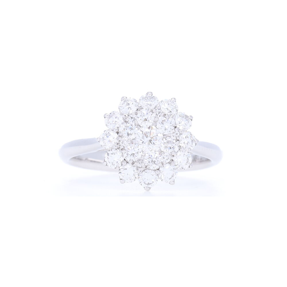 1.15 carats of diamonds is set into this clustered sun ring, set in 3.42 grams of 18k white gold - this ring feels feminine yet sturdy. Worn as an engagement ring or just a nice right hand ring, this ring mimics what a 3.5 carat diamond would look like in size. Huge bling in this ring, without the solitaire diamond price tag. 18k White Gold Brilliant Cut Diamond Cluster Sun Ring