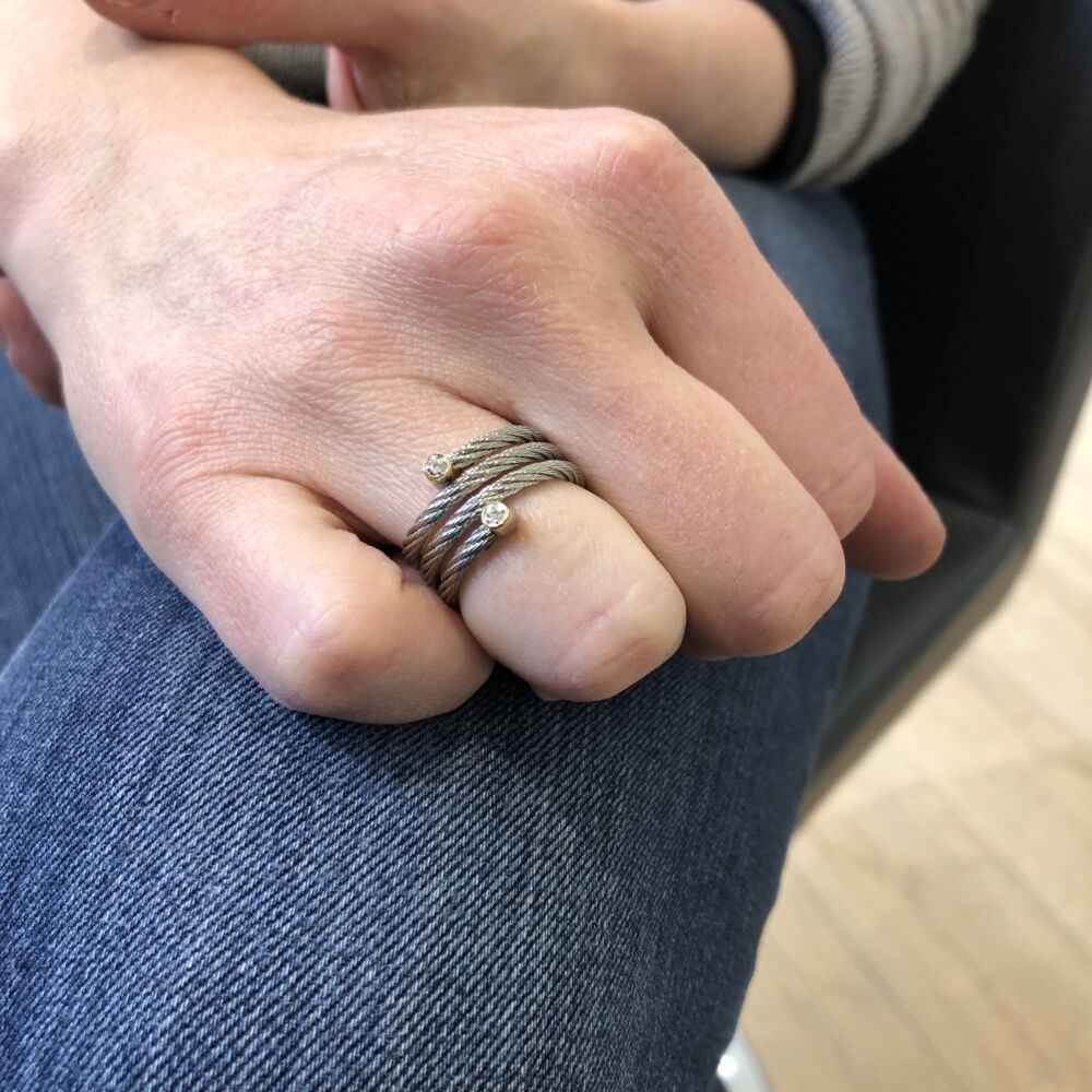 <div>This excitingly unique ring, features a heat treated steel grey colored cable, in a spring-like design. Displaying two 18k yellow gold diamond settings, weighing a total weight of .04 carats. This ring hugs the finger, being able to move with it more comfortably. </div> Classique Spring Ring