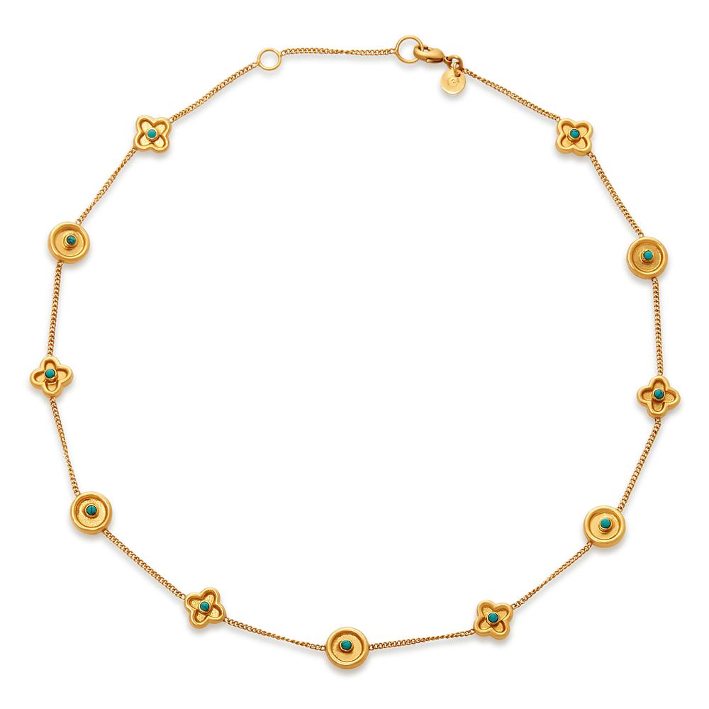This delicate 24k gold plate necklace features alternating circles and and flowers; accented with a center set of freshwater pearls on either side. Daphne Delicate Necklace