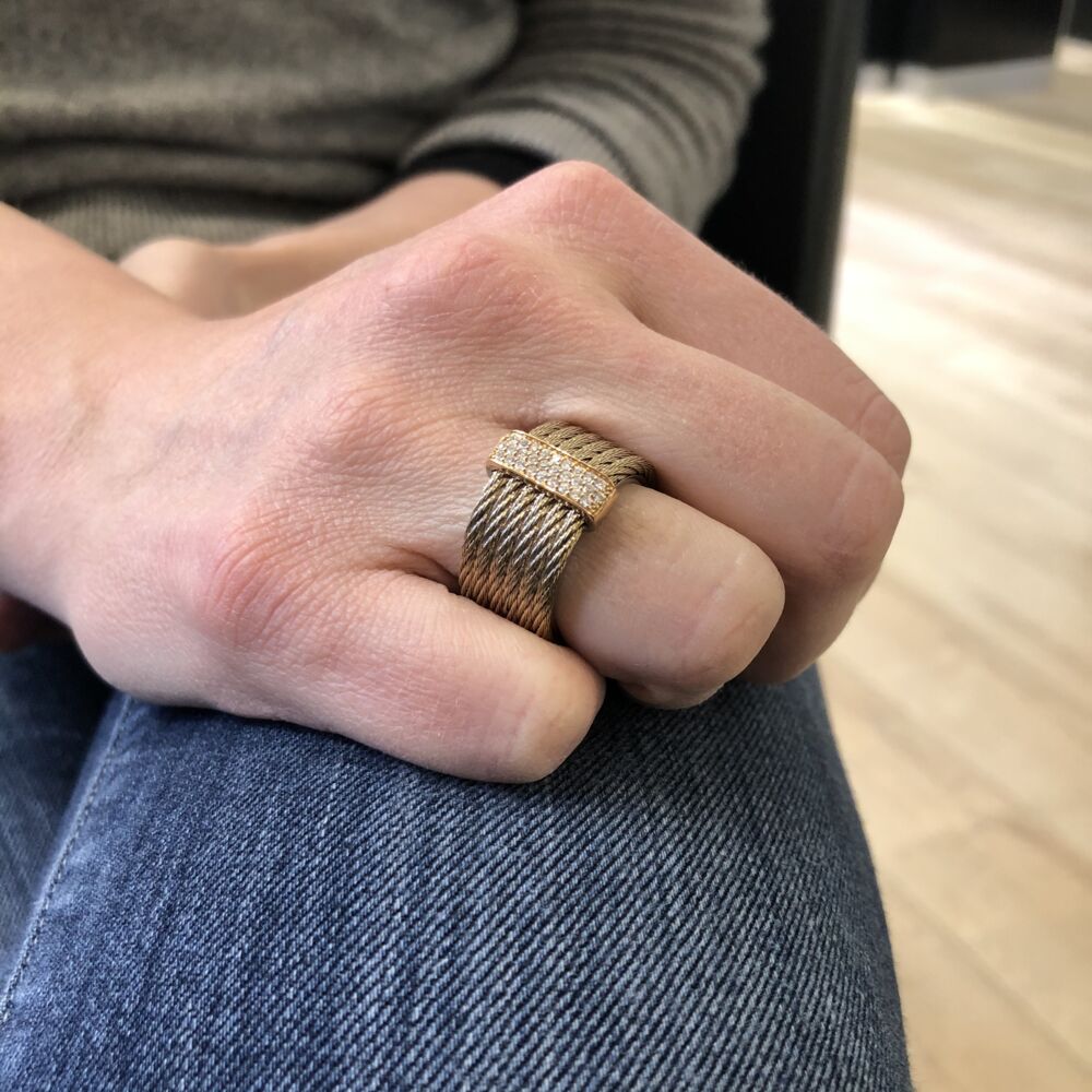 This carnation colored heat treated steel cable is lightweight and eye catching. Displaying six cable strands, with an 18k rose gold setting, with a total diamond carat weight of .23cts. Wear this ring for any occasion. Carnation Stacked Multi-Cable Ring