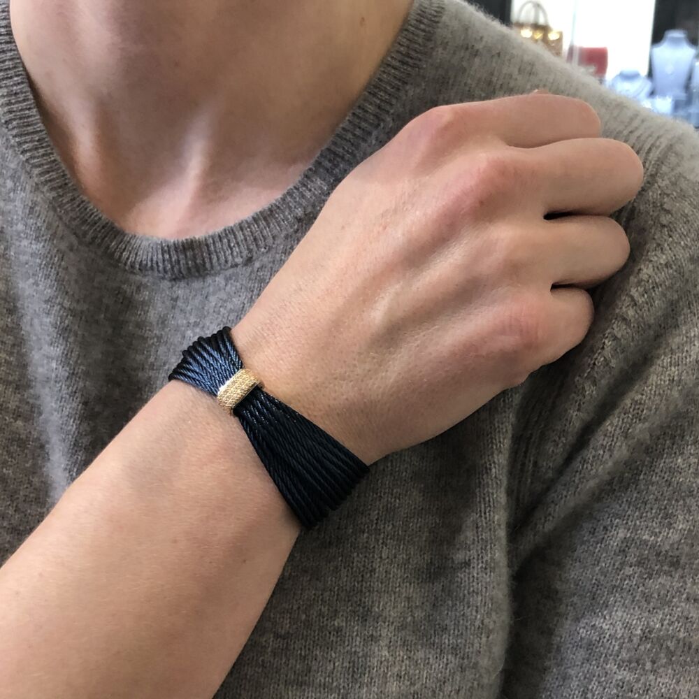 This blueberry heat treated cable features three, four strand bands crossing over each other, connecting on both ends. With an 18k rose gold diamond station displaying a total weight of .30 carats. This lightweight cable bracelet will redefine your day, while making a statement all its own. Wear stacked with others, or just alone to make an elegantly casual statement. Blueberry Multi-Cable Bangle