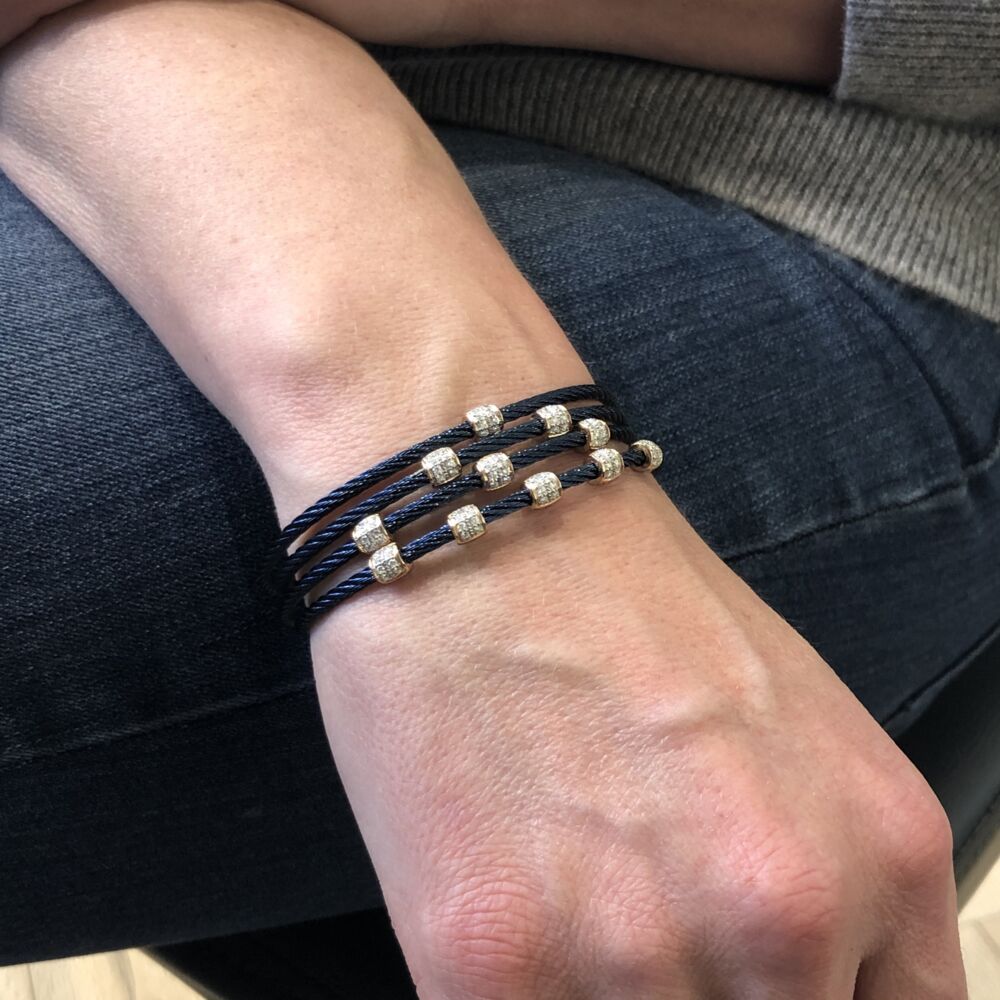 This heat treated blueberry colored cable features two ovaled 18k rose gold stations displaying a total carat weight of .13 carats. This bangle is perfect to stack multiple together, or wear alone. Blueberry Two Ovaled Station Bangle