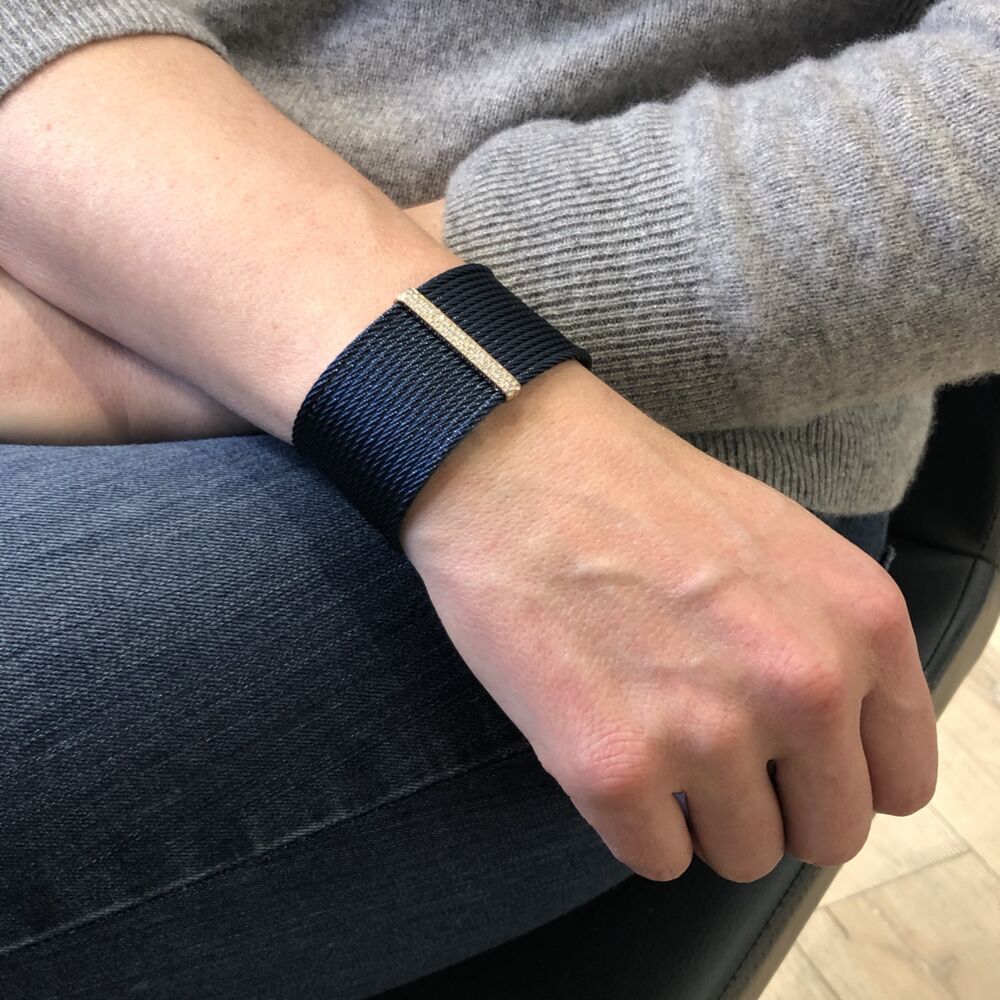 This heat treated steel blueberry colored cable, features an 18k rose gold displaying a diamond bar with a total carat weight of .56 carats. Hinged to fit all wrists, this cuff can be dressed up or down making it the perfect accessory. Blueberry Stacked Large Cuff