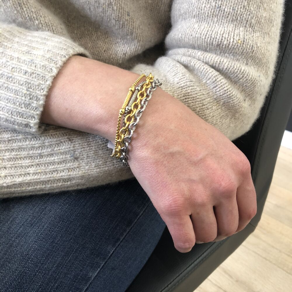 <div style="position: initial; margin: initial;"><span style="font-size: 1.2rem; position: initial; margin: initial;"><span style="font-size: 1.2rem; position: initial; margin: initial;">This two tone bracelet features two different colors. Also featuring two mixed metals; one large linked chain, and one very small linked chain with bar stations along its link. One of the large and the small links are displayed in yellow color, while the other two are displayed in grey color. Alternating in color and metal, the links are all connected at each end of the bracelet, letting it dance around on your wrist. Perfect to stack with others, or to wear alone.</span></span><br style="position: initial; margin: initial;"></div> Chain Reaction Two Toned Link Bracelet