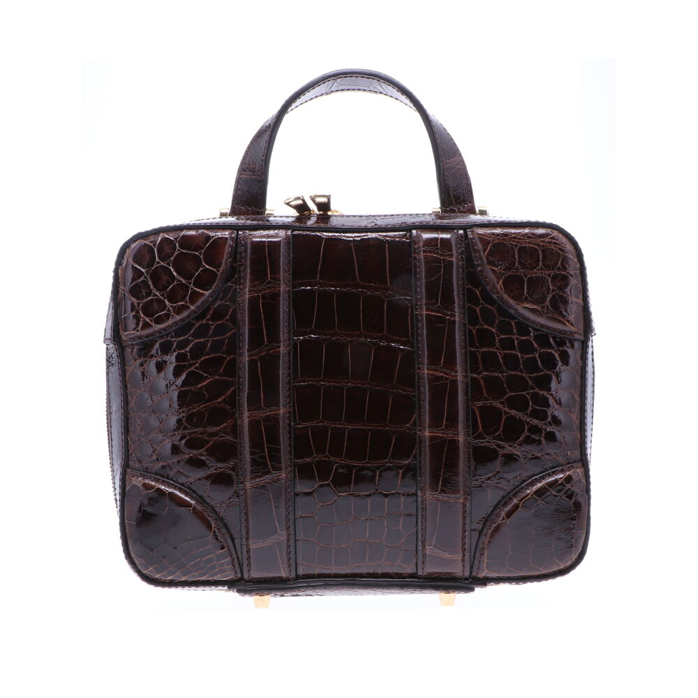 LaNae’s Luggage Bag can be an over the shoulder, crossbody or a top handle bag, that is made from genuine American Alligator. Proudly handcrafted in the USA by 3rd generation artisans, all edges are hand painted, interior is garment suede and is detailed with Italian palladium hardware. Each luxury bag is one of a kind and especially made for you to stand out against the crowd! Contact the store for additional photos. Brown Alligator Luggage Bag