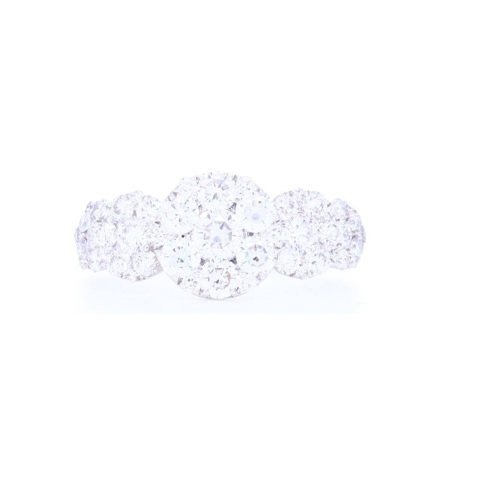 This beautiful clustered diamond circle station ring set in 18k white gold as 1.59 carats of diamonds. The pattern goes 1.2 way down the shank and is set in 3.55 grams of gold. A perfect right hand ring or nontraditional engagement ring. 18k White Gold Circle Cluster Diamond Ring