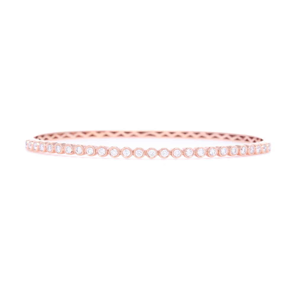 This 18k rose gold diamond bezel set bangle is a classic piece for any jewelry lovers collection. With sixteen round diamonds, totaling .54 carats, this beautiful bangle can be worn stacked or on its own and remains timeless either way. 18k Rose Gold Diamond Bezel Set Bracelet