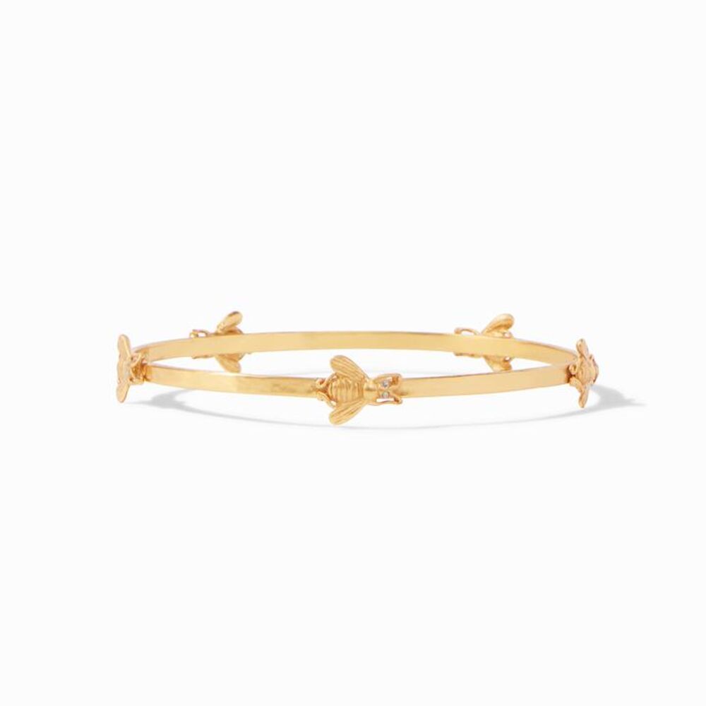 This whimsical bee bangle is perfect for those animal lovers in all of us. 24k gold plate bracelet with 5 bee stations on the bracelet featuring CZ stones as their eyes. Three different sizes available. Bee Bangle