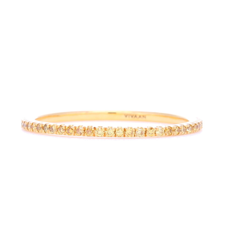 This thinner profile yellow diamond, yellow gold eternity stack ring is perfect to add that striking contrast to any stack ring set. Thin enough to be able to wear multiples in different colors, this is our go to ring for getting color in your stack with being the least limiting of how many you can put on. Super feminine profile. Contains about .35 carats of diamonds. Yellow Diamond Micro 18k Yellow Gold Stack Ring