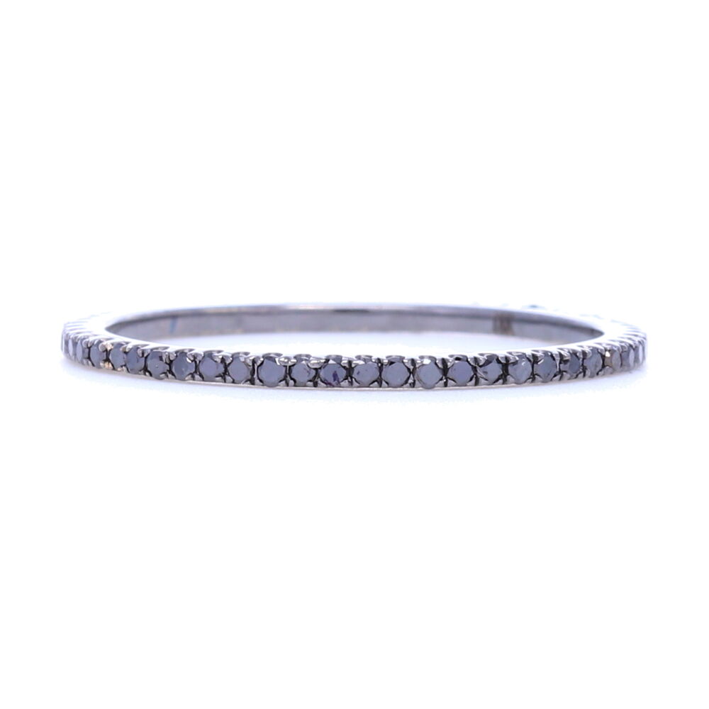 This thinner profile black diamond, black rhodium eternity stack ring is perfect to add that striking contrast to any stack ring set. Thin enough to be able to wear multiples in different colors, this is our go to ring for getting color in your stack with being the least limiting of how many you can put on. Super feminine profile. Contains about .35 carats of diamonds. Black Diamond Black Rhodium over 18k Gold Micro Diamond Eternity Stack Ring