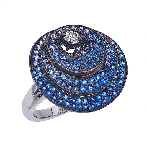 18k White Gold 3 Layered pave circle diamond and sapphire ring S: 3.44cts D:.2cts This artfully created ring is comprised of three gradient pave sapphire(3.44ct) disks, each stacked upon the other encapsulating the round brilliant diamond placed in the center. This ring is crafted entirely of 18k White Gold and then plated with Ruthenium, making the sapphire and diamond truly stand out. Three Layered Circle Sapphire Ring With Diamonds