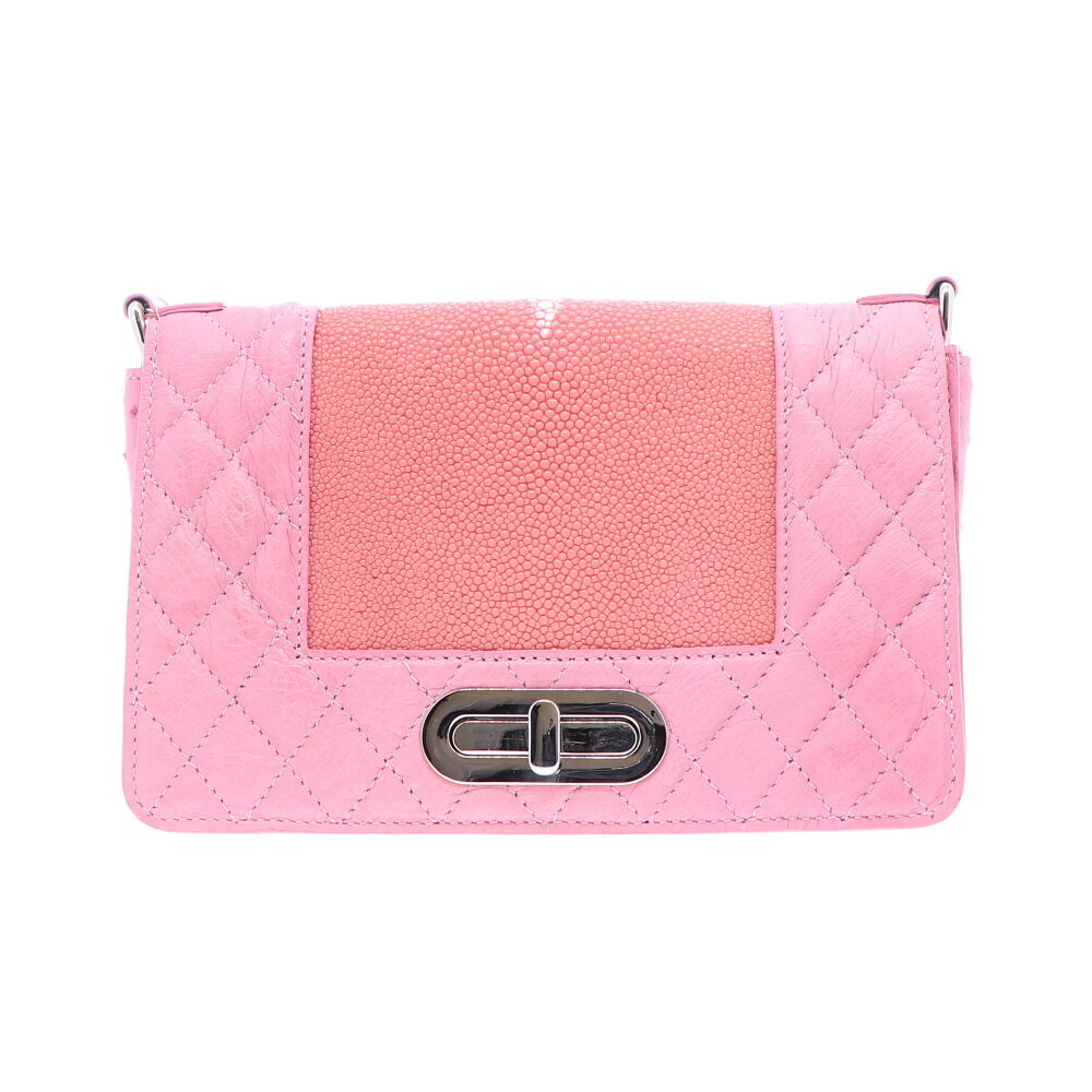 LaNae's Chain Bag has been crafted of genuine Ostrich and Stingray leather finished in a unique Pink color. Each handbag is crafted using the finest Italian Palladium Hardware including a magnetic swiveling closure as well as a chain and d-rings. The interiors are lined using a strong yet light garment quality suede. Each of LaNae's one of a kind bags have been proudly produced in the USA. Pink Ostrich and Stingray Chain Bag