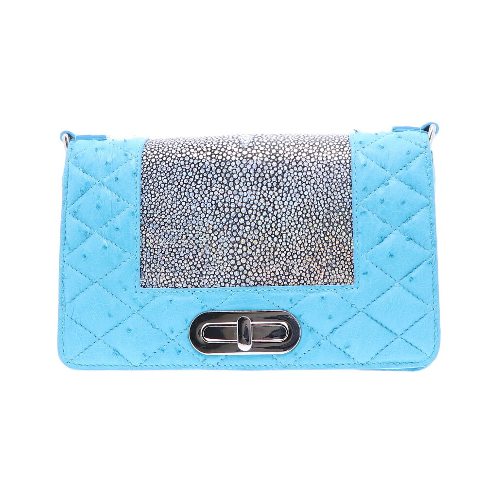 LaNae's Chain Bag has been crafted of genuine Stingray and Ostrich leather colored with a unique Silver and Sky Blue finish. Each handbag is crafted using the finest Italian Palladium Hardware including a magnetic closure as well as a chain and d-rings. The interiors are lined using a strong yet light garment quality suede. Each of LaNae's one of a kind bags have been proudly produced in the USA. Baby Blue Ostrich Chain Bag
