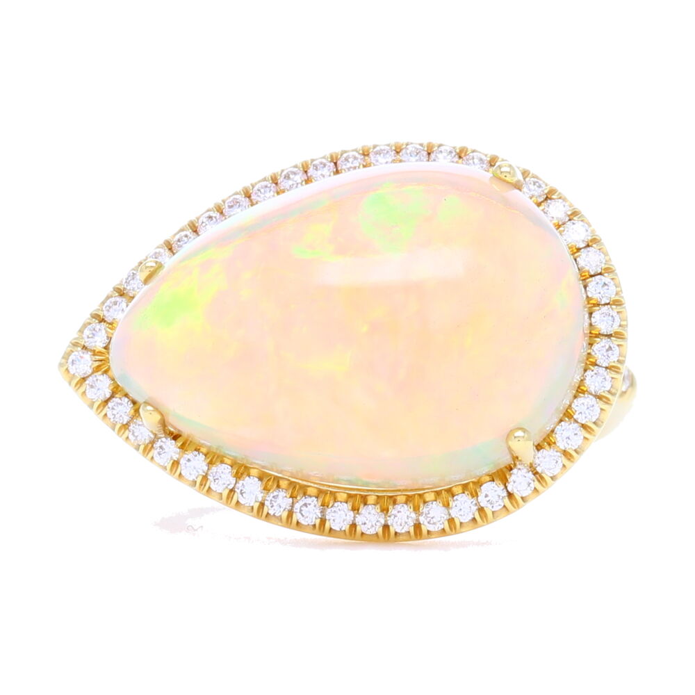 Gorgeous, handpicked tear drop cabochon Ethiopian opal ring with feminine diamond halo. Made from 18k yellow gold by goldsmiths that work directly with Lauren K in NYC, this ring has stunning craftsmanship and attention to detail. Super comfortable to wear and one-of-a-kind, you'll never regret this splurge. 18k Tear Drop Cabochon Ethiopian Opal Ring with Diamond Halo