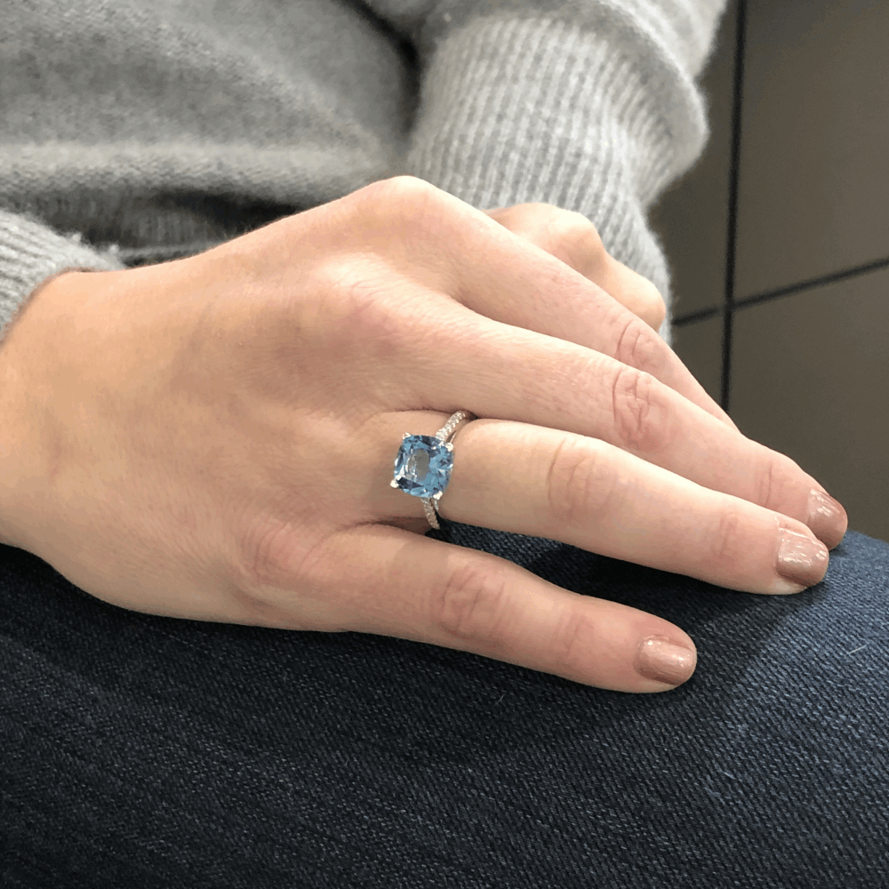 This stunning ring by designer Lisa Nik is made from 18k White Gold with 0.14tcw of Diamond running down each side of the shank, in the center sits a beautiful cushion cut London Blue Topaz. 18k London Blue Topaz Ring with Diamonds